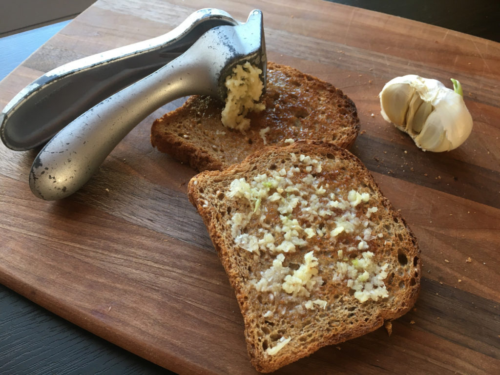 freshly minced clove of garlic on toast for sore throat